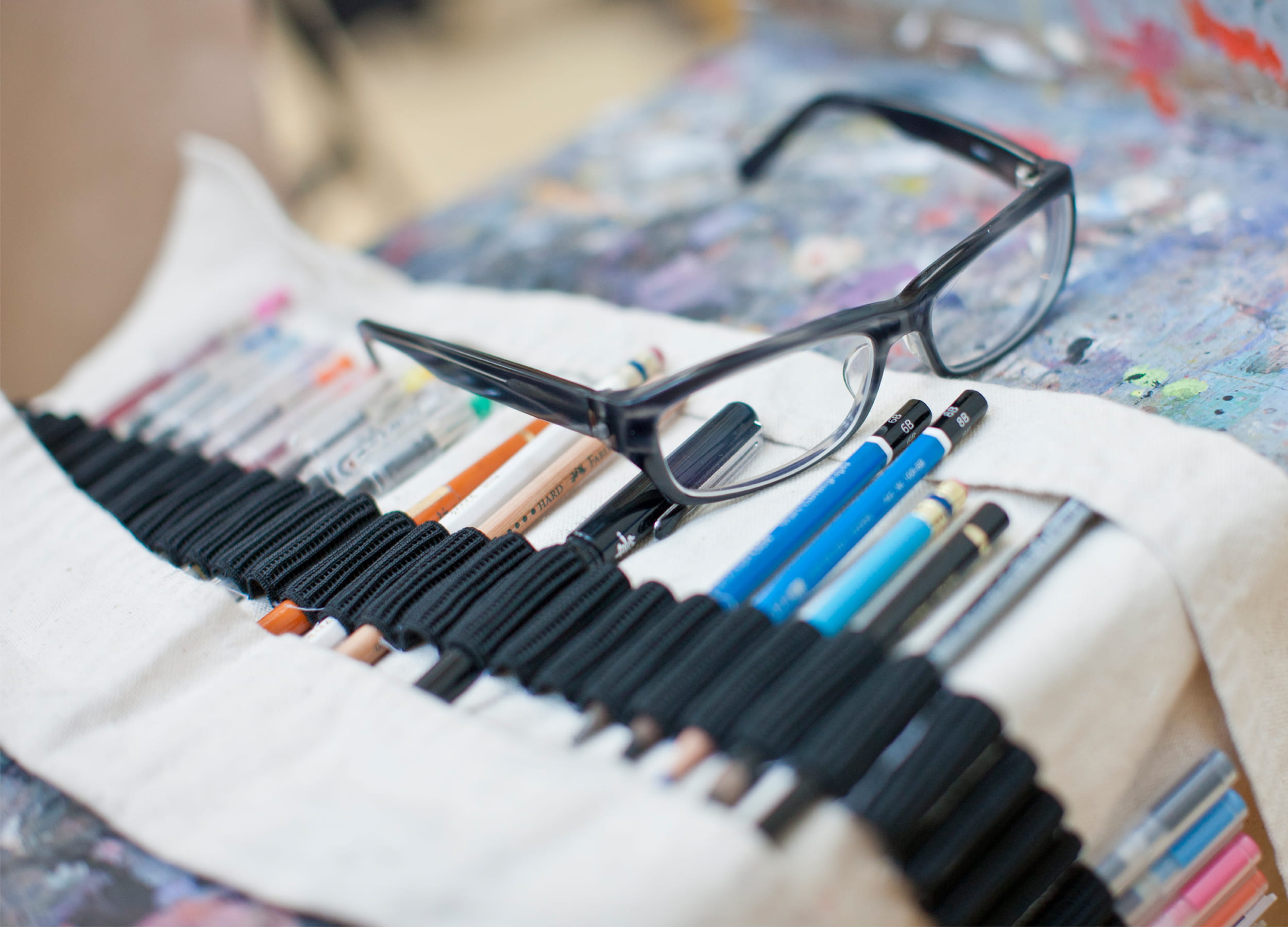 Eye glasses sitting on a pencil set